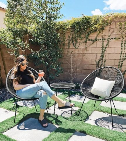 The weather-resistant garden furniture set made of PE rattan and glass, perfect for outdoor use.